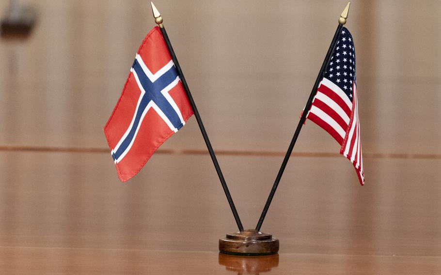 Small American and Norwegian flags are displayed together on a table.