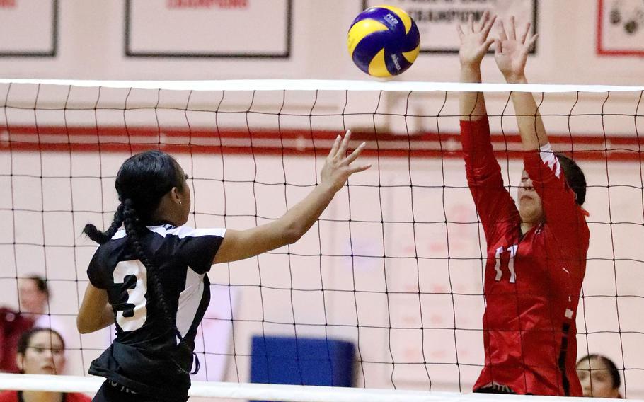 Zama's Kalease Brown tries to hit the ball past E.J. King's Maliwan Schinker during Saturday's DODEA-Japan girls volleyball match. The teams split their weekend series, Zama winning in five sets Friday and King in four sets Saturday.