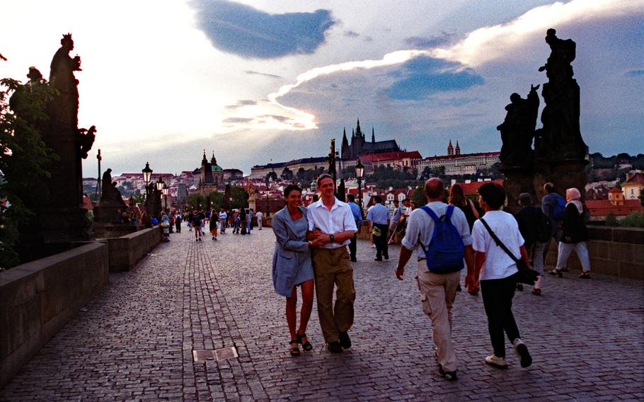 People take an evening stroll on Prague's Charles Bridge. Beginning next year, many U.S. military personnel living and working in Europe will have to apply for leisure travel authorization using a new system that requires personal details.