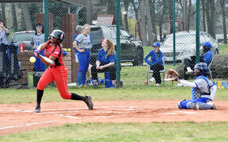 Kaiserslautern senior Aries Garrett swings at a pitch during the second game of Saturday's doubleheader against Ramstein on Ramstein Air Base, Germany. Catching is Ramstein's Ilana Johnson.