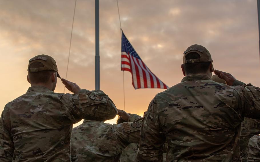 Military personnel salute in formation during a Veterans Day ceremony at Yokota Air Base, Japan, Nov. 9, 2023. 