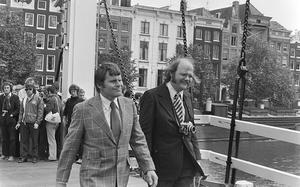 This black and white photo shows actors Bruce Glover and Putter Smith on the set of a James Bond movie.