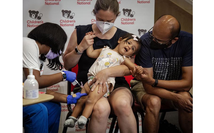 Nurse Reisa Lancaster administers coronavirus vaccine to 14-month-old Ada Hedge as she is comforted by her mother, Sarah Close, and father, Chinmay Hedge, on June 21 in Washington, D.C. 