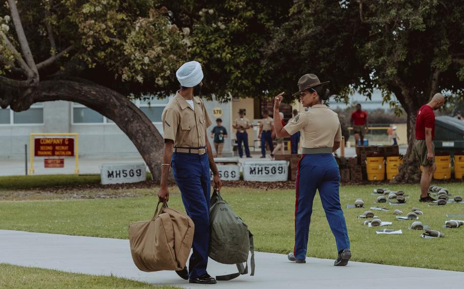 Pfc. Jaskirat Singh, left, passes a drill instructor at Marine Corps Recruit Depot San Diego in California on Aug. 14, 2023. Singh graduated with the Marine Corps’ Golf Company, 2nd Recruit Training Battalion.