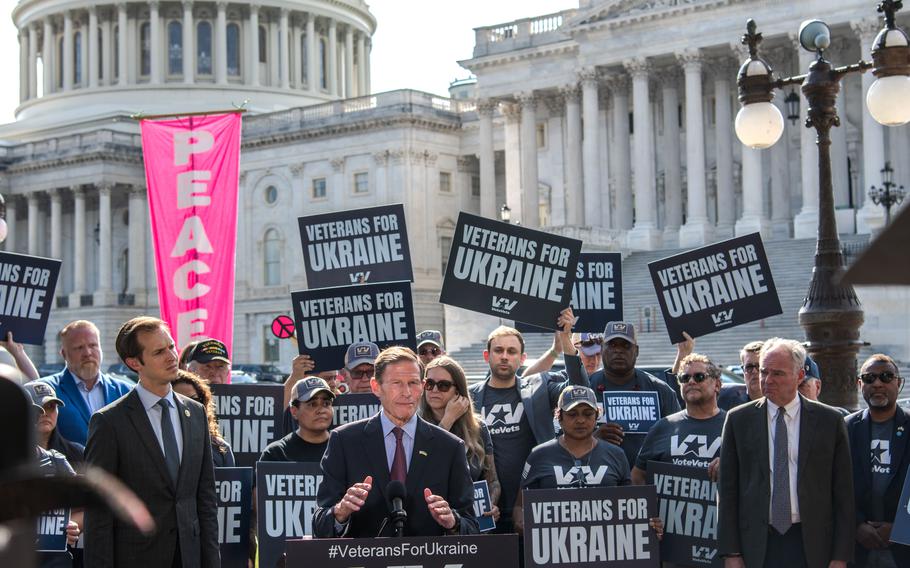 Sen. Richard Blumenthal, D-Conn., speaks outside the U.S. Capitol on Oct. 3, 2023, calling for continued support for Ukraine. Rep. Jake Auchincloss, D-Mass, left, and Sen. Tim Kaine, D-Va., right, stand among veterans with the group VoteVets holding up signs in support of Ukraine.