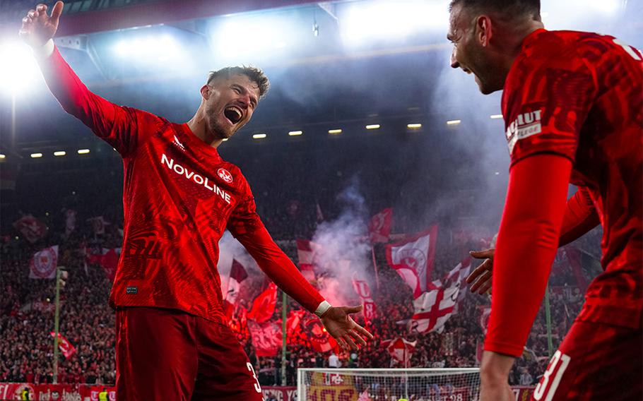 Kaiserslautern soccer players wearing red uniforms celebrate a win.