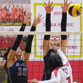 Seisen's Aina Sekido and Ariana Hill go up to block Nile C. Kinnick's Michelle Holloway during Tuesday's Kanto Plain volleyball match. The Phoenix won in five sets.
