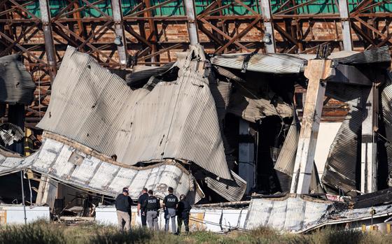 Officials investigate the rubble of the historic Tustin Marine Corps Air Station blimp hangar on Wednesday, November 8, 2023 after a fire destroyed the WWII-era structure. (Photo by Mindy Schauer, Orange County Register/SCNG)