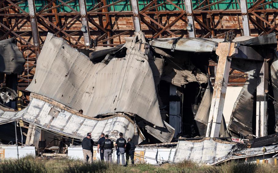 Officials investigate the rubble of the historic Tustin Marine Corps Air Station blimp hangar on Wednesday, November 8, 2023 after a fire destroyed the WWII-era structure.