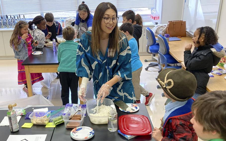 Aki Messisco shows students how to make temaki, cone-shaped sushi, at John O. Arnn Elementary School near Camp Zama, Japan, Feb. 15, 2024.