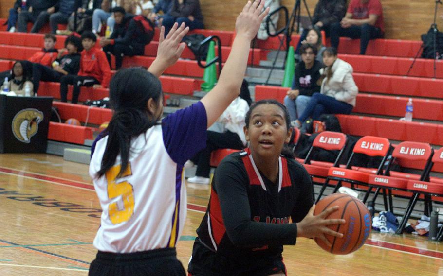 E.J. King's Moa Best looks to shoot against Sasebo North's Uta Yamasaki during Saturday's Japan girls basketball game. The Cobras won 65-38.