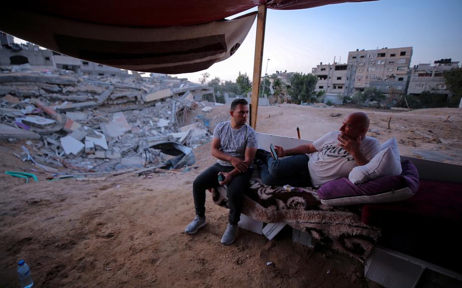 Kayan Abu Safiya, right, and his son Yazid, rest outside their destroyed home in Beit Lahia. 