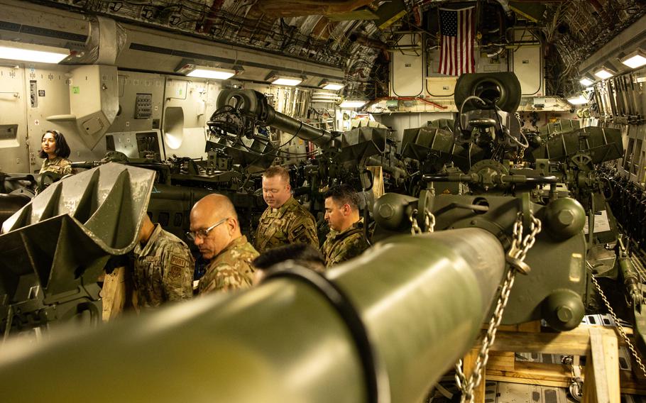 Marines load 155 mm M777 howitzers into the cargo hold of an Air Force C-17 Globemaster III at March Air Reserve Base, Calif., on April 21, 2022. 
