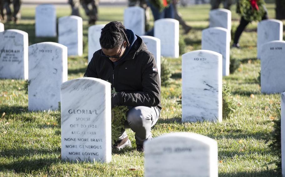 Volunteers participate in the 32nd Wreaths Across America Day in Section 60 of Arlington National Cemetery, Arlington, Va., Dec. 16, 2023. 