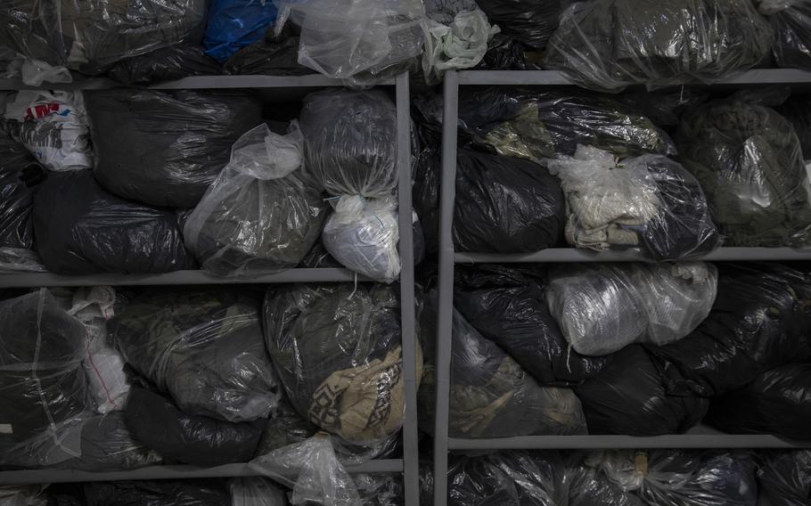 Bags of clothes containing uniforms and clothing belong to captured Russian prisoners of war.