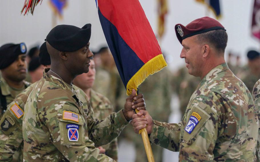 Lt. Gen. Michael E. Kurilla, XVIII Airborne Corps commander (right), passes the 10th Mountain Division colors to Brig. Gen. Milford Beagle Jr., during the division change of command ceremony July 12 at Wheeler-Sack Army Airfield. 