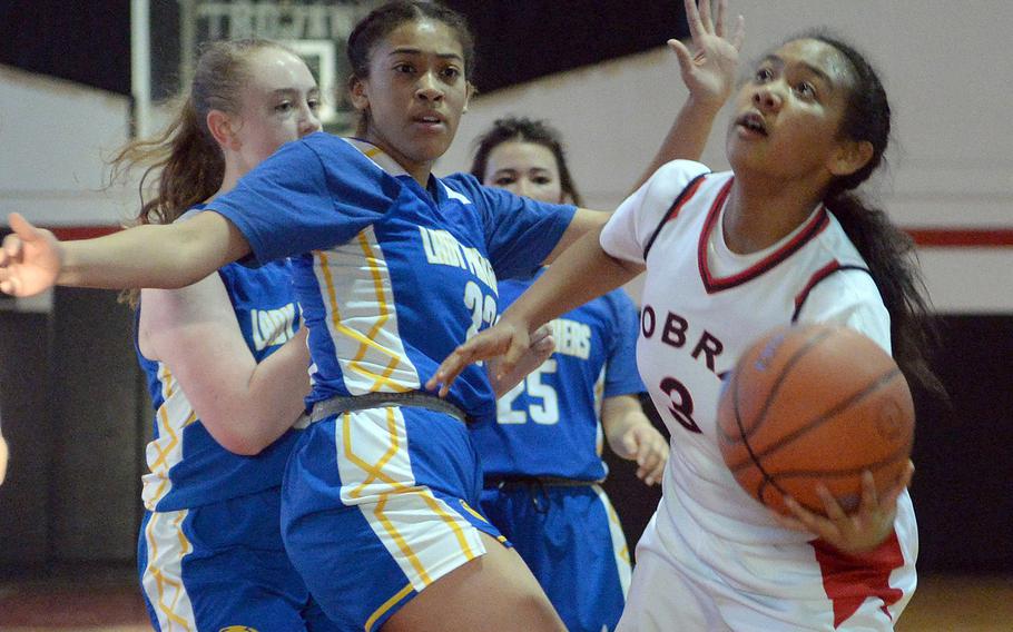 E.J. King's Moa Best puts up a scoop shot past Yokota's Christina Smith during Friday's semifinal in the DODEA-Japan girls basketball tournament. The Cobras won 51-13 and will face Nile C. Kinnick in Saturday's final.