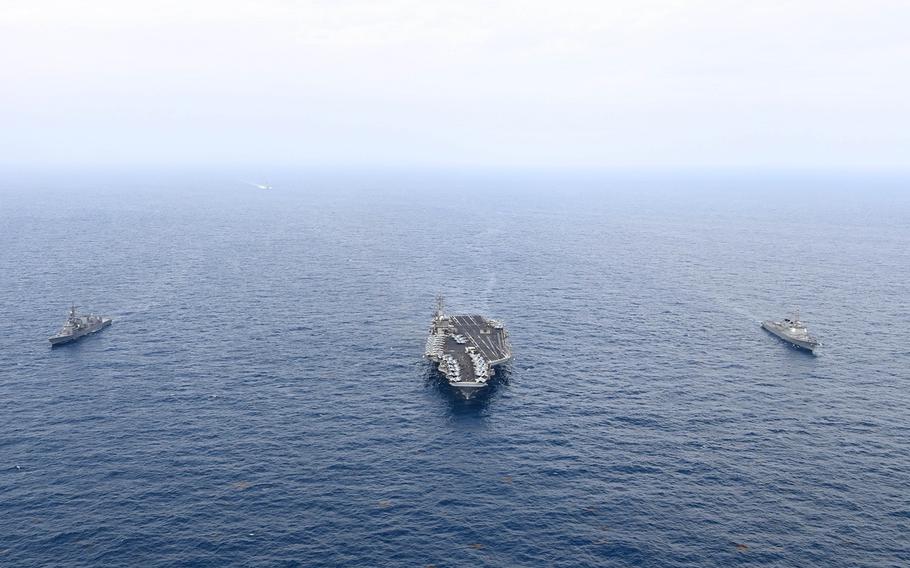 The aircraft carrier USS Theodore Roosevelt trains with the Japanese destroyer JS Ariake, left, and South Korean destroyer Seoae Ryu Seong-ryong south of Jeju Island, South Korea, April 11, 2024.