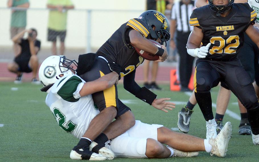 Kubasaki's Kaito Moore corrals Kadena quarterback Cameron Wilson.