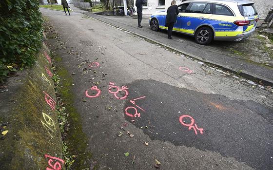 Police forensics markers are paint at a crime scene where two girls was attacked on their way to school in Illerkirchberg near Ulm, Germany, Monday, Dec. 5, 2022. (Bernd Weissbrod/dpa via AP)