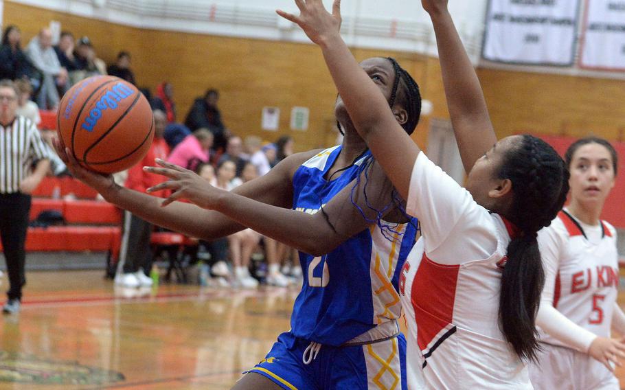 Yokota's Beverly Gardner shoots against E.J. King's Moa Best during Friday's DODEA-Japan girls basketball game. The Cobras won 60-39.