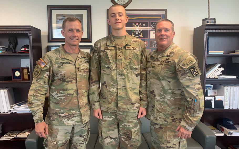 Army Pvt. Matthew Cole, center, poses July 5, 2023, at Fort Moore, Ga., with Maj. Gen. Curtis Buzzard, left, commander of the Maneuver Center of Excellence, and Col. Jimmy Hathaway, commander of the 198th Infantry Brigade.