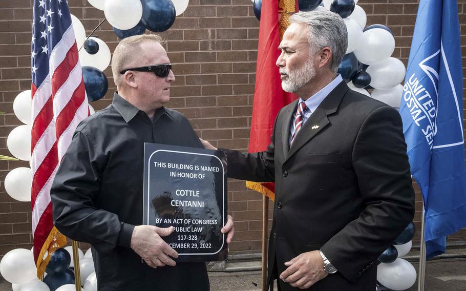 Jon Centanni, father of LCpl. Rick Centanni, receives a replica of a plaque from U.S. Post Office Manager of Customer Relations Robert Fernades following a post office renaming in Yorba Linda, CA on Friday, March 17, 2023. The post office will be called the Cottle Centanni Post Office Building. Centanni and SgtMaj Robert Cottle, both Yorba Linda residents, were killed in combat in Iraq during Operation Enduring Freedom. 