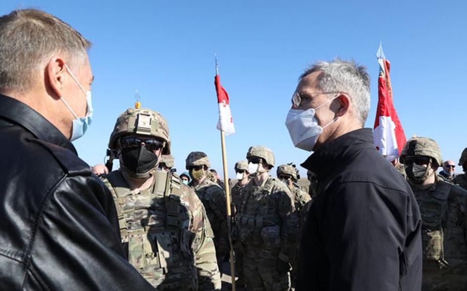 NATO Secretary-General Jens Stoltenberg, right, visits Mihail Kogalniceanu Military Base, Romania, Feb. 11, 2022, to greet U.S. 2nd Cavalry Regiment troops deployed to reassure allies. 