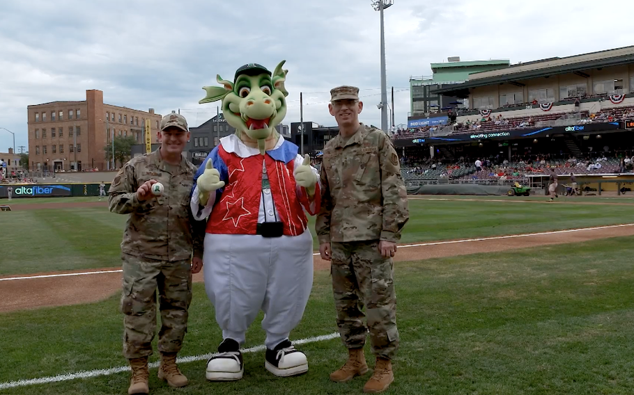 Service members from Wright-Patterson Air Force Base pose with the Dayton Dragons mascot. 