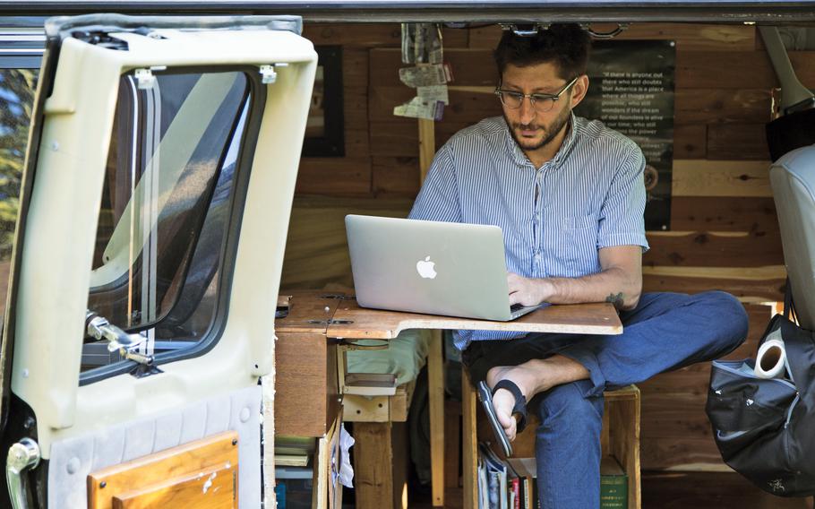 In this 2018, photo, U.S. journalist Danny Fenster works out of his van that he made into a home/office in Detroit. Myanmar’s military-installed government spokesman said Thursday, Sept. 30, 2021, that Fenster, detained in the Southeast Asian country four months ago, was arrested for actions incompatible with his professional duties.