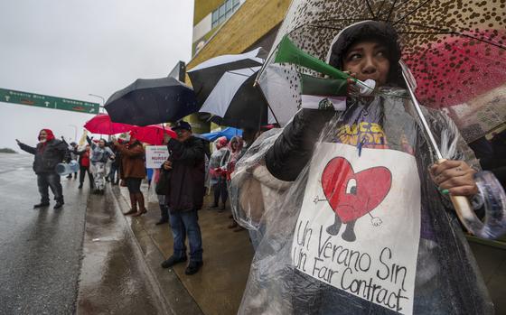 Los Angeles Unified School District, LAUSD teachers and Service Employees International Union 99 (SEIU) members strike under heavy rain asking for a fair contract outside the Edward R. Roybal Learning Center in Los Angeles Tuesday, March 21, 2023. Tens of thousands of workers in the LAUSD are walking off the job over stalled contract talks. (AP Photo/Damian Dovarganes)