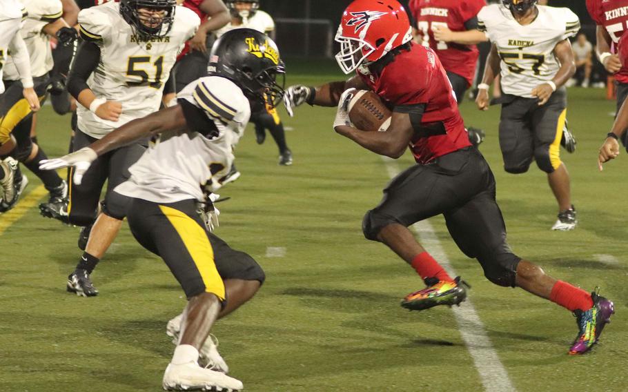 Nile C. Kinnick's Tre Bennett looks for running room against Kadena's defense.