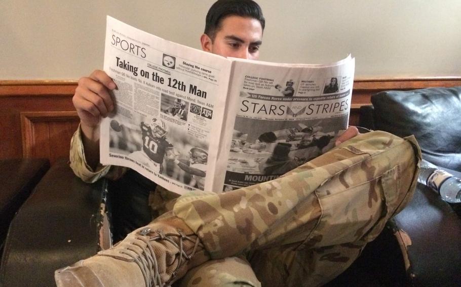 A soldier reads a copy of Stars and Stripes while waiting for a flight from Bagram Air Base Sept. 19, 2019.