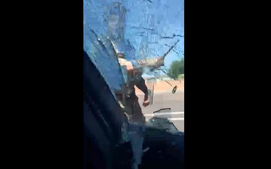 In this screenshot from a Facebook video, a window in Tati Gonzalez's car shatters as a security forces airman at Mountain Home Air Force Base, Idaho, hits it with his baton. 