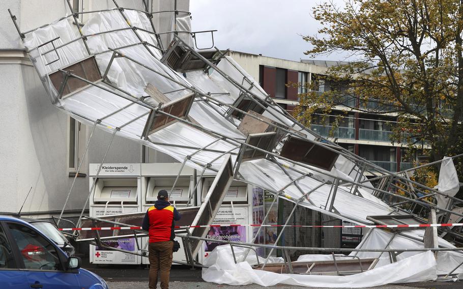 A collapsed scaffold lies in front of a house in Wuerzburg, Germany, Thursday, Oct. 21, 2021. Germany is hit by heavy rain and storms. 