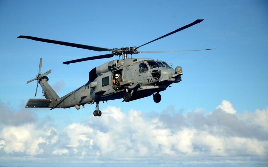 An MH-60S Seahawk helicopter prepares to land aboard the USS Ronald Reagan during a multi-carrier exercise in the Philippine Sea, Monday, Nov. 6, 2023. 