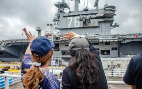 Sailors' family members wave farewell as the aircraft carrier USS Ronald Reagan departs Yokosuka Naval Base, Japan, May 16, 2024.