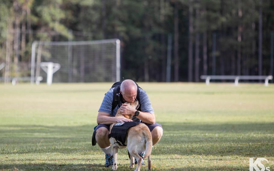 Veteran Mark Heid gives some love to his service dog, Mama Bear, at K9s For Warriors’ headquarters in Ponte Vedra Beach, Fla. Heid was paired with Mama Bear in December 2022.