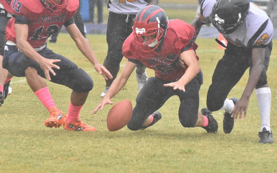 Aviano's Joshua Barthold and Vicenza's Ezo Lane chase after a loose ball Saturday, Oct. 22, 2022. Barthold recovered the fumble, one of the Cougars' five fumble recoveries in Aviano's 40-0 win.
