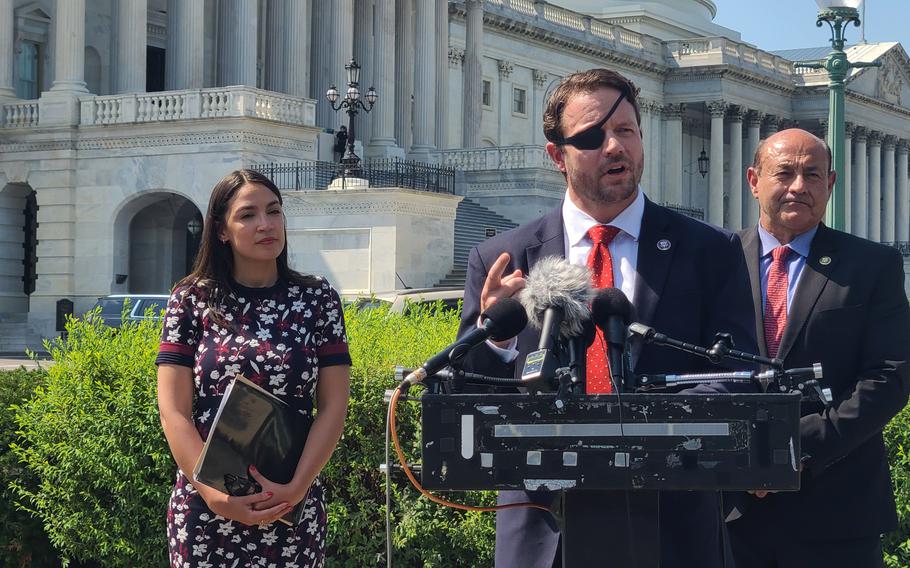 Rep. Dan Crenshaw, R-Humble, discusses the use of psilocybin and other mood-altering drugs to treat PTSD and other trauma, at the U.S. Capitol on July 13, 2023. He and Rep. Alexandria Ocasio-Cortez, D-N.Y. (left) worked on a provision ordering the Pentagon to begin trials. At right is another supporter of the measure, Rep. Lou Correa, D-Calif.