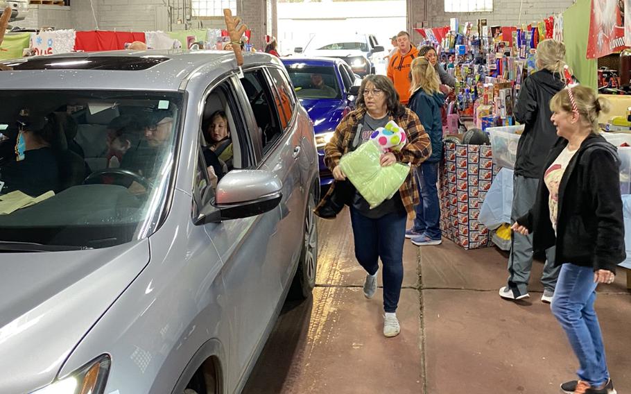 Volunteers Mickey Hall left, and Marilyn Gann, right, handed out clothing and blankets at the 2019 toy giveaway in McAlester, Okla. 