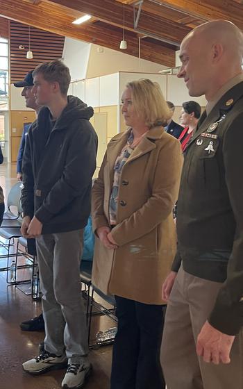 People standing at a ceremony.