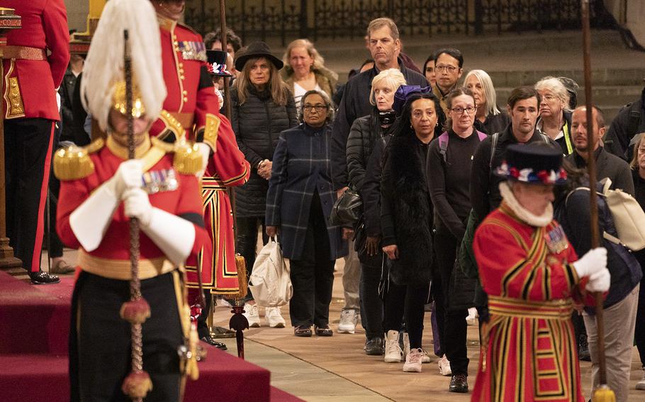 Members of the public line up to pay their respects. 