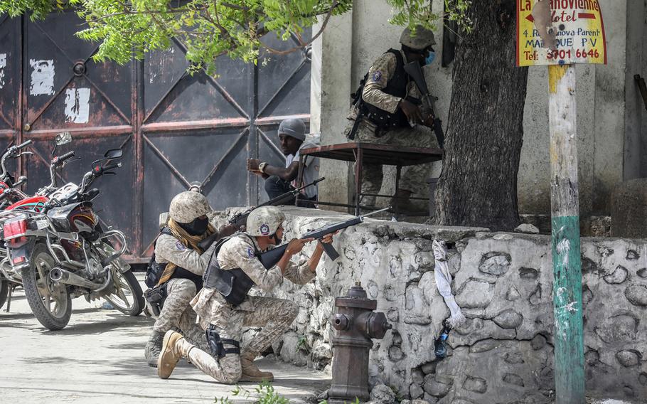 Police exchange fire with armed men next to the Petionville police station in Port-au-Prince on July 8, 2021. (Valerie Baeriswyl/AFP via Getty Images/TNS)