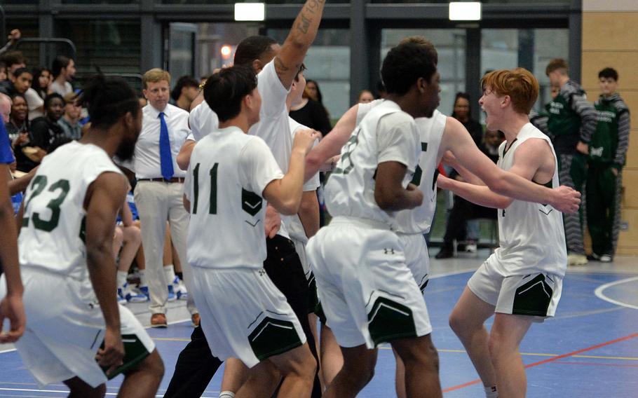 The Naples Wildcats celebrate their Division II title after defeating Rota 46-25 in the Division II championship game at the DODEA-Europe basketball finals in Ramstein, Germany, Feb. 18, 2023. 