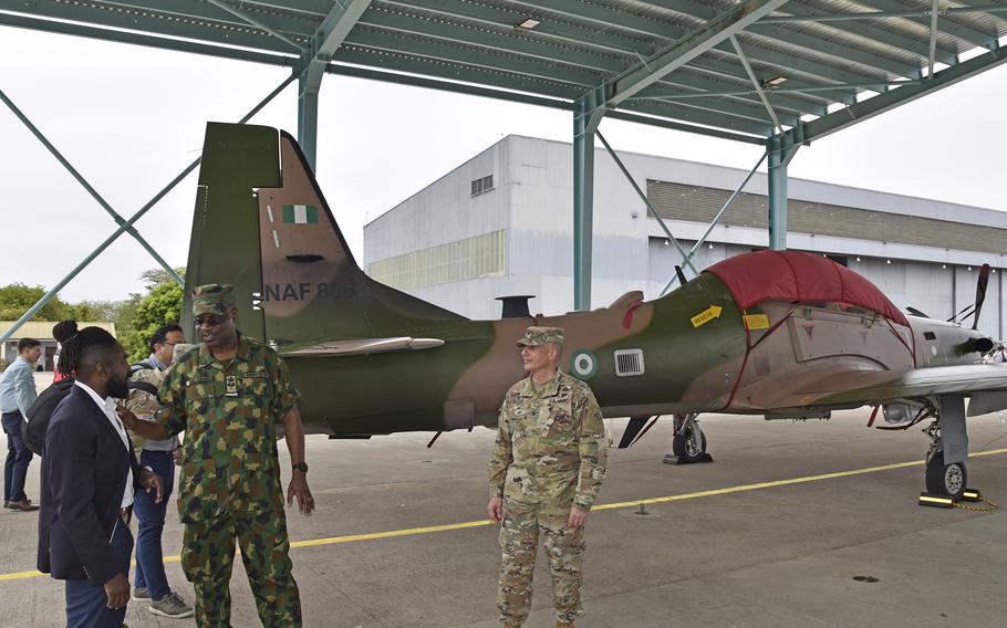 Members of the U.S. Army Corps of Engineers join Nigerian air force air commodore MA Akiode in  touring an A-29 Super Tucano at Kainji Air Base in Nigeria on April 27, 2023. They participated in a ribbon cutting for several construction projects at the base supporting recently delivered aircraft. 