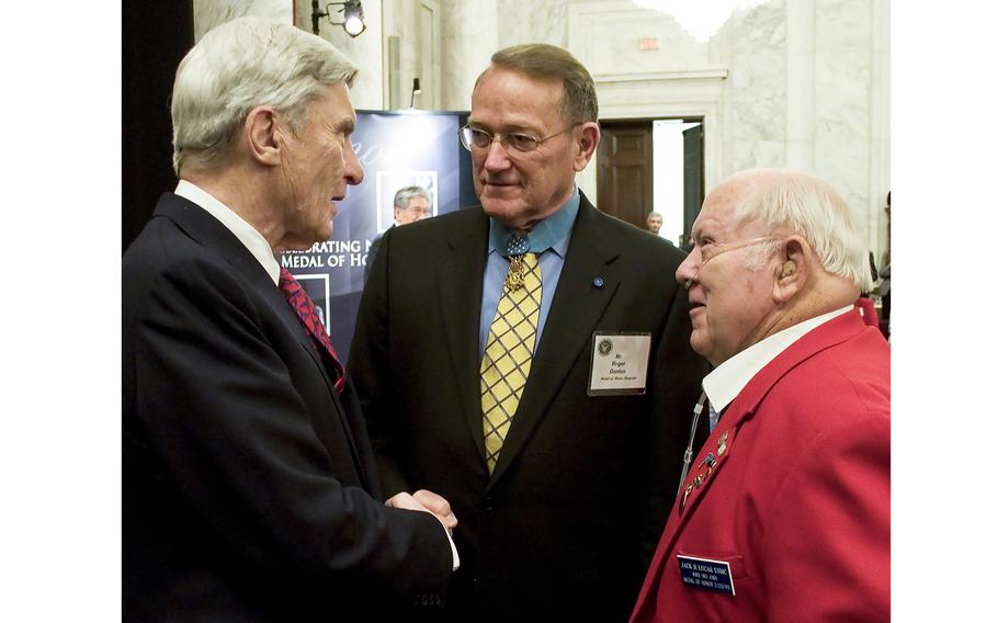Sen. John Warner, R-Va., left, talks with Medal of Honor recipients Roger Donlon, center, and Jack Lucas at a ceremony in Washington in 2007.