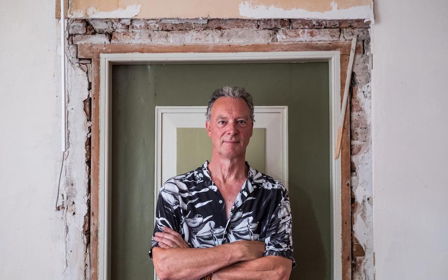 More than 26,000 homes in the northern Dutch province of Groningen have been severely damaged by earthquakes triggered by drilling for natural gas. Ger Warink stands in a doorway of his house in Loppersum. He has been living across the street while his home is repaired.