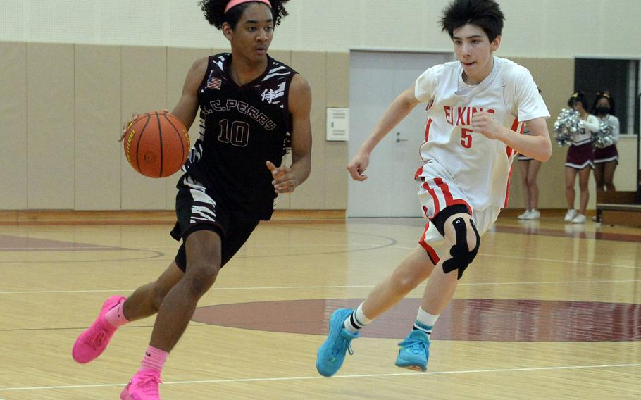 Matthew C. Perry's Shion Fleming and E.J. King's Cameron Reinhart beat a path upcourt during Saturday's DODEA-Japan boys basketball game. The Samurai won 48-39.