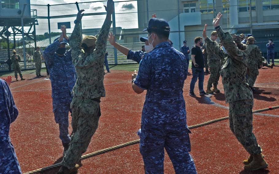 U.S. and Japanese sailors celebrate their tug-of-war victory during Fleet Week Japan at Yokosuka Naval Base, May 25, 2022.